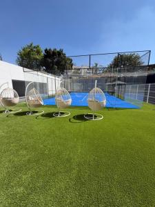 a group of chairs sitting on a soccer field at Departamento Prestigio 97 in Guadalajara