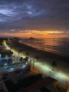 a view of a beach at night with the ocean at Praia dos Sonhos - Suítes in Itanhaém
