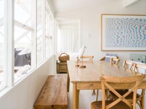 a dining room with a wooden table and chairs at Walters in East Ballina