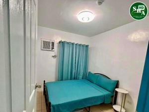 a room with a blue bed in a room at JHS Condo in Davao City +13 photos