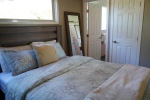 a bedroom with a large bed and a window at East Side Beach House in Santa Cruz
