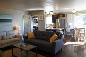 a living room with a couch and a table and a kitchen at East Side Beach House in Santa Cruz