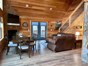 a living room with a couch and a table at Riverfront Blue Jay Cabin in Murphy