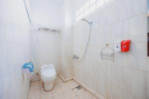 a bathroom with a toilet and a shower at RedDoorz Plus at Amalio Hotel Surapati in Bandung +19 photos