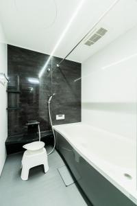 a bathroom with a white toilet in a room at Flower Base Botan in Fukuoka