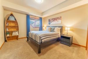 a bedroom with a bed and a window at Cascade Penthouse by Canadian Rockies Vacation Rentals in Canmore