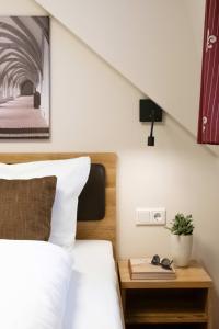 a bedroom with a bed and a bedside table at Doppelzimmer 11 in Heidenheim
