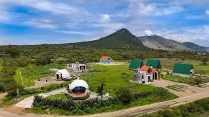 an aerial view of a farm with mountains in the background at Domo La Gloria Tolantongo in Cardonal