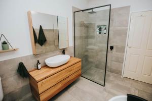 a bathroom with a sink and a shower at The Nest! in Cannonvale +18 photos