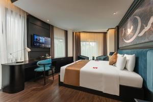 a hotel room with a bed and a desk at HALO HANOI HOTEL in Hanoi +36 photos