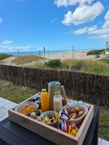 a tray of food on a table near the beach at VIENTOS apartments in Villa Gesell
