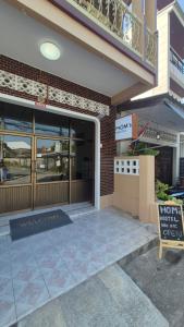 a front door of a store with a sign in front at HOM's HOSTEL in Phuket