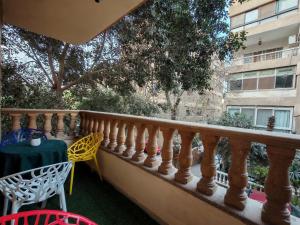 a balcony with a table and a table and chairs at Museum Land Boutique Hotel in Cairo