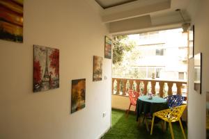 a room with a table and chairs and paintings on the wall at Museum Land Boutique Hotel in Cairo