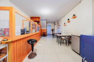 a dining room with a table and chairs at Hotel C18 at Cibaduyut Mitra RedDoorz in Bandung +18 photos