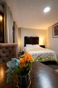 a bedroom with a bed and a vase of flowers on a table at Hospedaje chakana inn in Cusco +20 photos