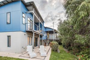 a blue and white house with white chairs at Ocean Blue - Gnarabup NEW in Gnarabup