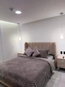 a bedroom with a large bed with two pillows at Adagio Quito Suite de Lujo in Quito