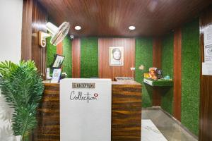 a reception counter in a room with green walls at Hotel O by OYO Sawariya Regency in Bhopal