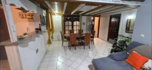 a living room and dining room with a table and chairs at Au cœur de douenel bouillante cheques vacances acceptées in Bouillante +7 photos