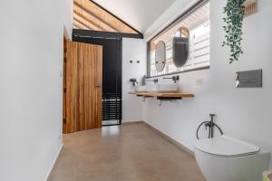 a bathroom with a toilet and a sink and a mirror at The Cosy Sunset Beach Resort in Thong Sala +220 photos