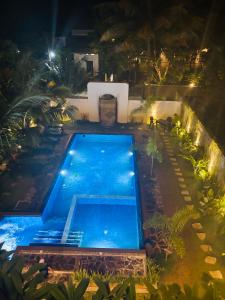 an overhead view of a swimming pool at night at Asiri guest house in Dickwella