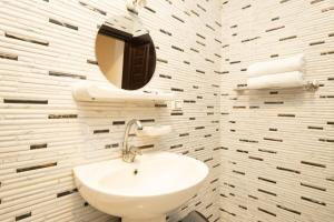 a white bathroom with a sink and a mirror at Museum Land Boutique Hotel in Cairo +72 photos