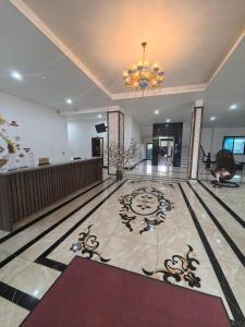 a lobby with a chandelier and a tile floor at LS HOTEl in Kim Bảng