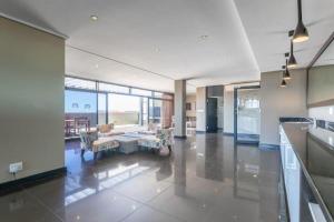 a large room with a table and chairs in a building at Manhattan Escape Suite By Ezey Tours in Cape Town