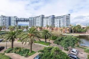 a view of a city with palm trees and buildings at Manhattan Escape Suite By Ezey Tours in Cape Town