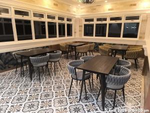 a restaurant with tables and chairs in a room at IT Farm Resort in Rizal