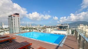 a swimming pool on the roof of a building at Golden Rose Hotel in Danang