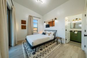 a bedroom with a bed and a bathroom at Brycegate Retreat. Stunning Views. Modern Comforts. in Hatch
