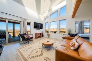 a living room with a couch and a table at Brycegate Retreat. Stunning Views. Modern Comforts. in Hatch