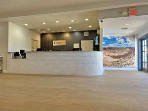 a lobby with a reception desk in a building at Clarion Pointe Winslow I-40 in Winslow