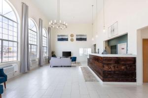 a large room with a lobby with windows and a desk at Quality Inn Winslow I-40 in Winslow