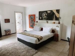 a bedroom with a large bed in a room at Casa Artista By Kresna Hospitality in Seminyak +127 photos