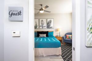 a bedroom with a bed and a ceiling fan at Seaside Flamingo Retreat in Oceano