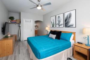 a bedroom with a bed and a ceiling fan at Seaside Flamingo Retreat in Oceano