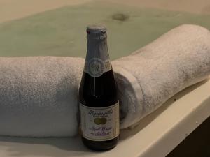 a bottle of wine sitting next to a towel at Lafayette Inn & Suites in Indianapolis +60 photos