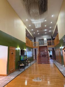 a large lobby with a staircase and a stair case at Lafayette Inn & Suites in Indianapolis