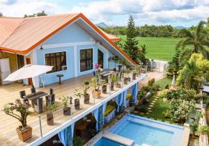 an aerial view of a house with a swimming pool at TUBURAN Poolside in Nagsulang