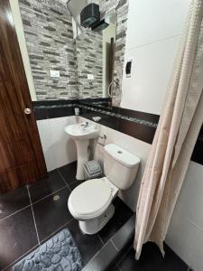a bathroom with a toilet and a sink at Santa Ana Home Cusco in Cusco +27 photos