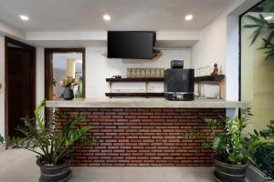 a kitchen with a brick counter with a tv at Stay Siem Reap in Siem Reap