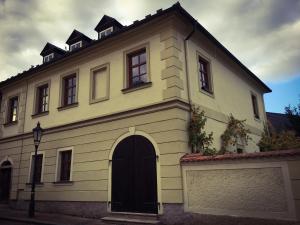 a white house with a black door at Kutná Hora Apartment in Kutná Hora