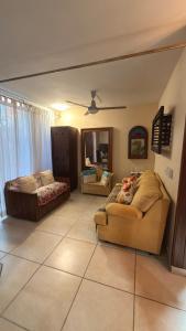 a living room with two couches and a couch at Hacienda en Primavera, descanso Familiar total in Puerto Vallarta