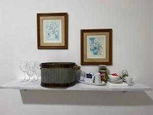 a shelf with a pot and plates on it at La Esquina AT in San Pedro