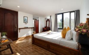 a bedroom with a large bed with white sheets at Stay Siem Reap in Siem Reap +84 photos