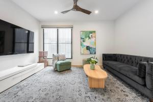 a living room with a couch and a table at Oak & Ivy on Windsor in Williamstown