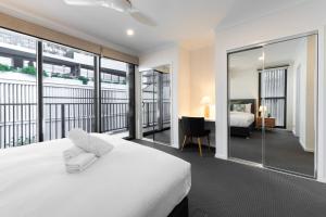 a hotel room with a bed and a balcony at Oak & Ivy on Windsor in Williamstown